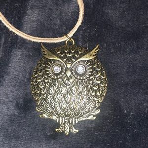 Owl necklace on leather.